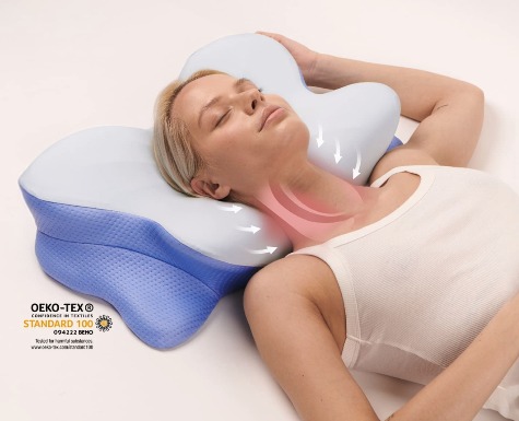 Person sleeping on an ergonomic contoured cervical pillow